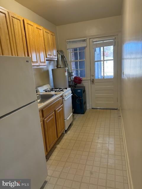 kitchen featuring water heater and white appliances