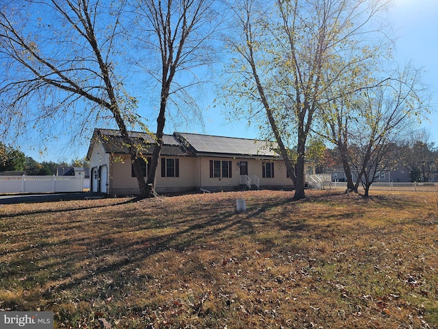 rear view of property featuring a yard