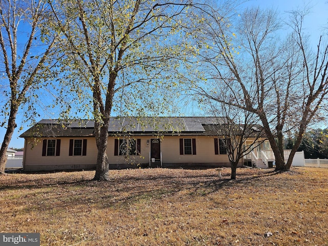 ranch-style house with a front lawn