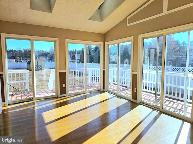 unfurnished sunroom with lofted ceiling