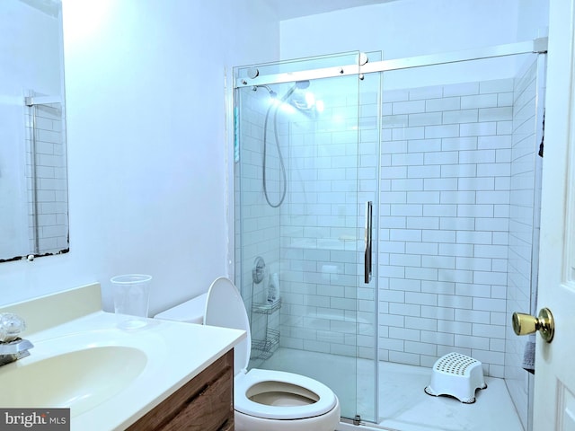 bathroom with walk in shower, vanity, and toilet