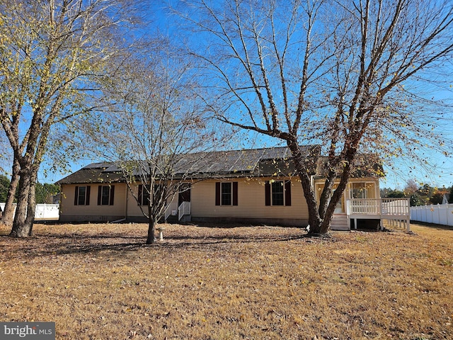 rear view of house featuring a yard