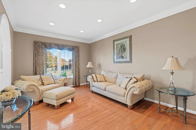 living area with crown molding, recessed lighting, and light wood-style floors