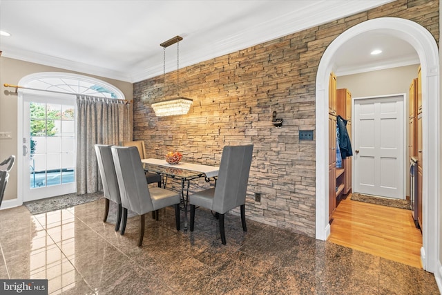 dining space with arched walkways, recessed lighting, and ornamental molding
