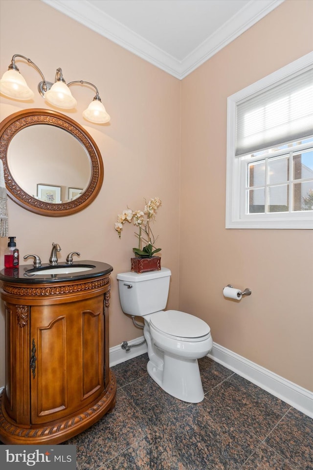 half bathroom featuring vanity, baseboards, ornamental molding, tile patterned floors, and toilet