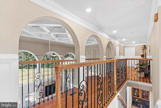 hall featuring crown molding, beamed ceiling, recessed lighting, wood finished floors, and coffered ceiling