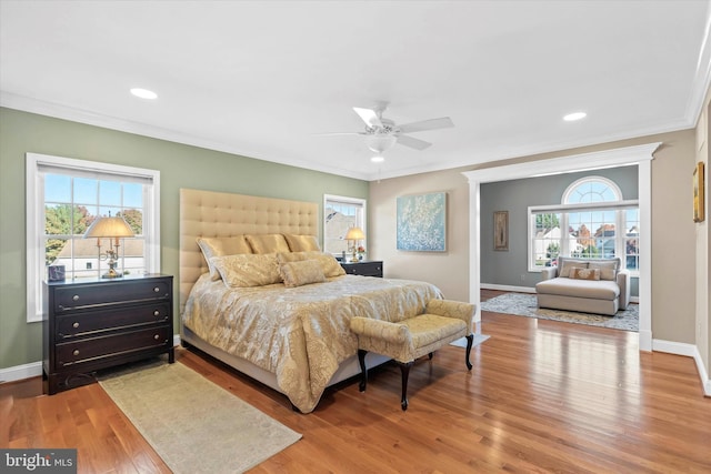 bedroom with recessed lighting, baseboards, crown molding, and wood finished floors