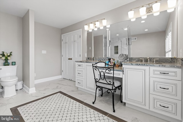 bathroom with toilet, marble finish floor, baseboards, and vanity