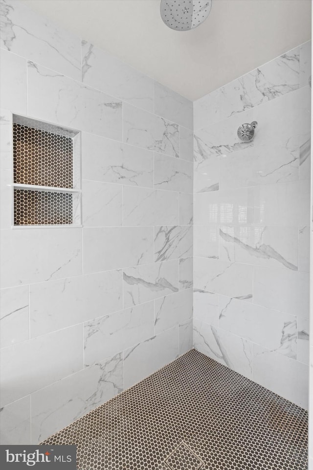 bathroom with tiled shower