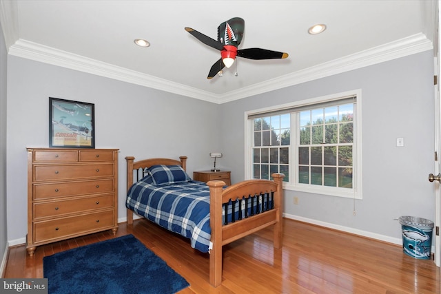 bedroom with recessed lighting, baseboards, ornamental molding, and wood finished floors
