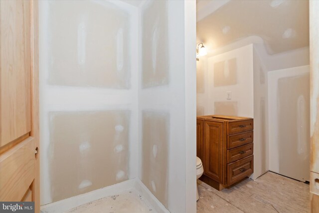 bathroom featuring toilet and wood finished floors