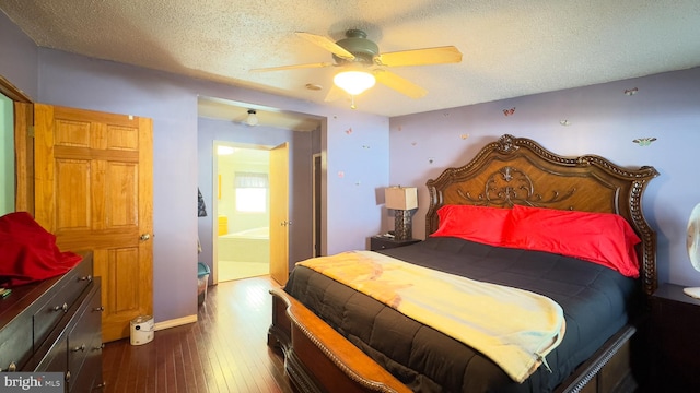 bedroom featuring dark wood-type flooring, a textured ceiling, ceiling fan, and ensuite bathroom