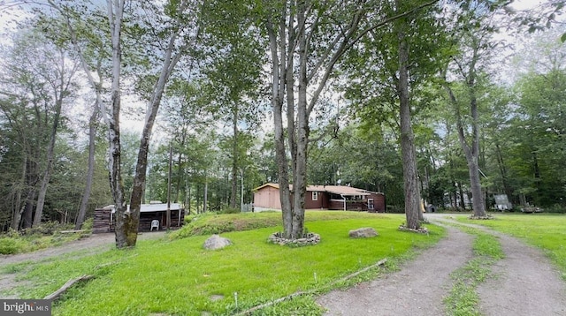 view of front of home with a front yard and an outdoor structure