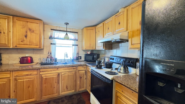 kitchen with black appliances, pendant lighting, sink, and backsplash