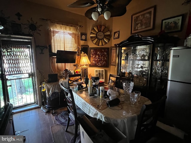 dining room with hardwood / wood-style flooring and ceiling fan