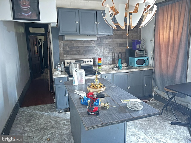 kitchen with decorative backsplash, sink, a kitchen island, and electric range