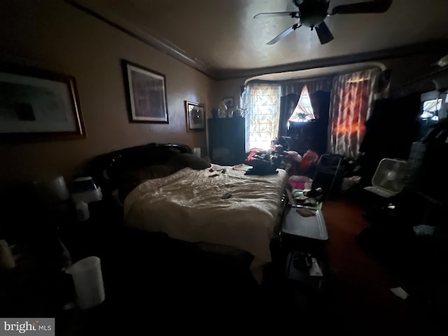 bedroom with ceiling fan and crown molding