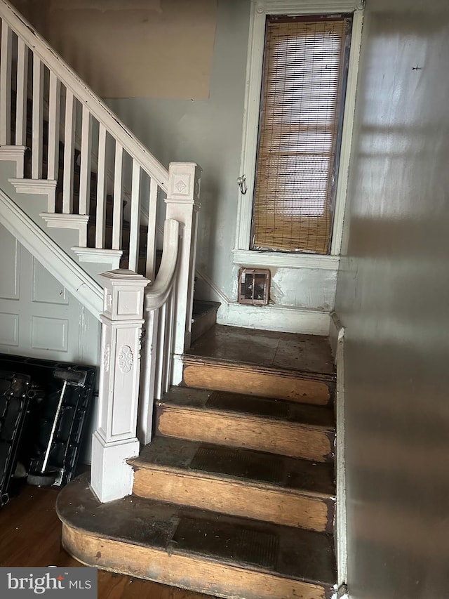 stairway with hardwood / wood-style floors