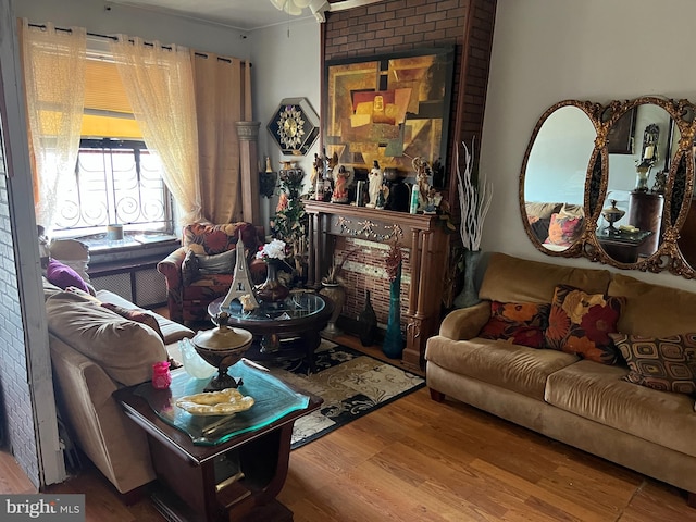 living room with wood-type flooring and ornamental molding