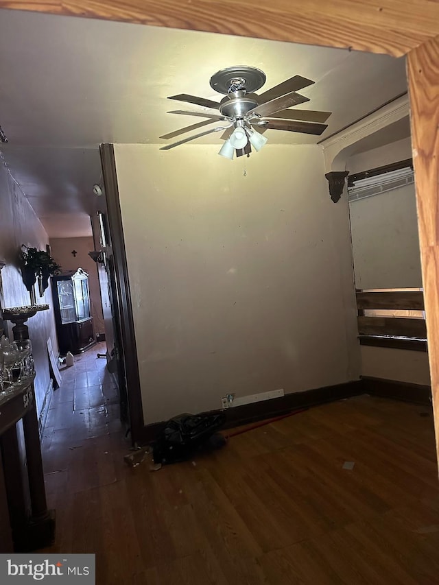 empty room with dark wood-type flooring and ceiling fan