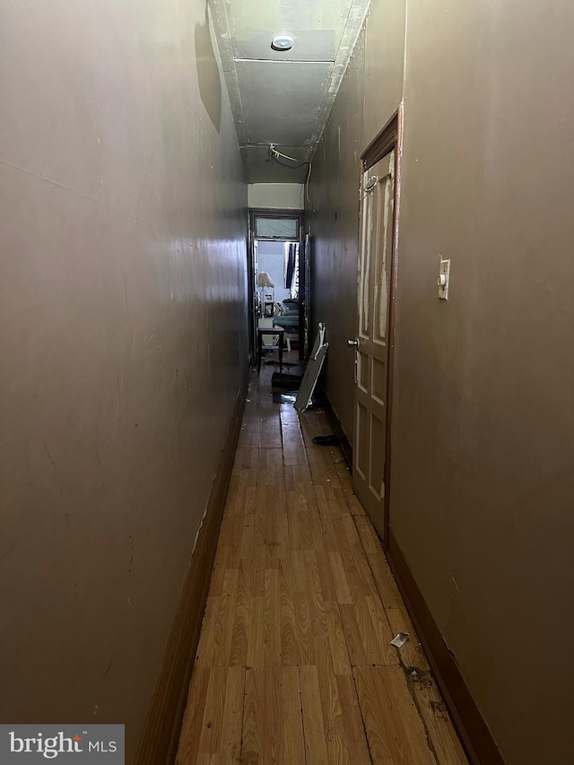 hallway with hardwood / wood-style flooring