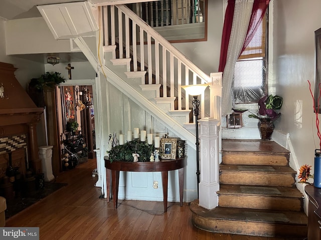 stairs featuring hardwood / wood-style floors