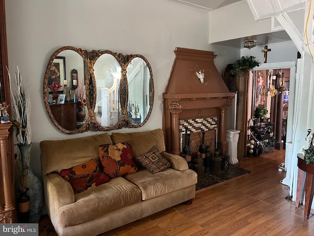 living room with hardwood / wood-style floors and a tile fireplace