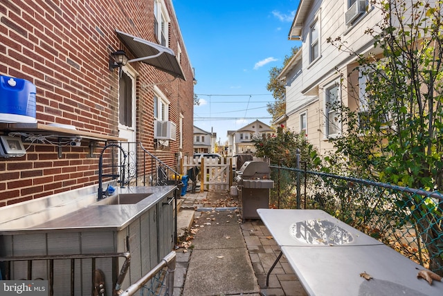 view of patio with grilling area and cooling unit