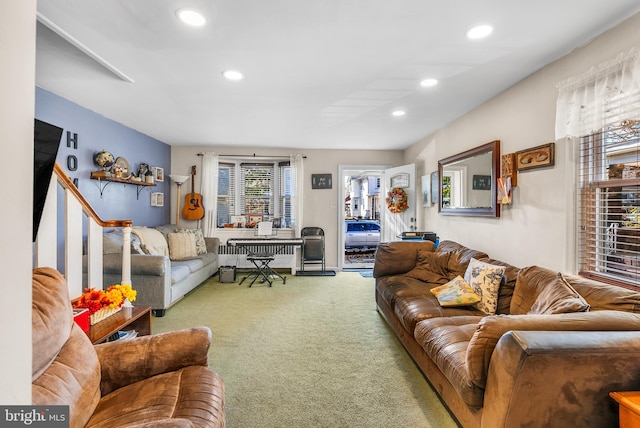 carpeted living room with plenty of natural light and radiator heating unit