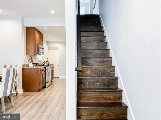 staircase with hardwood / wood-style floors