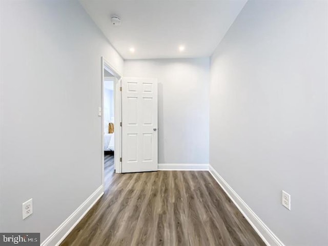 hallway with dark hardwood / wood-style flooring