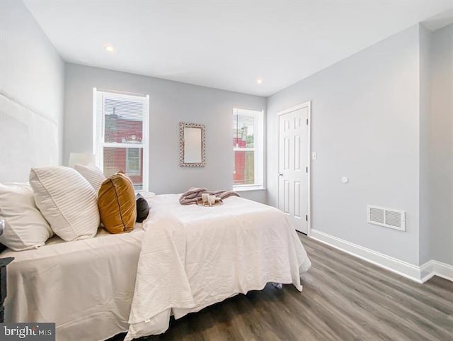 bedroom with dark hardwood / wood-style flooring