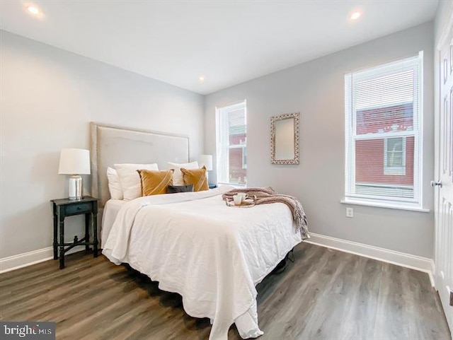 bedroom with dark wood-type flooring