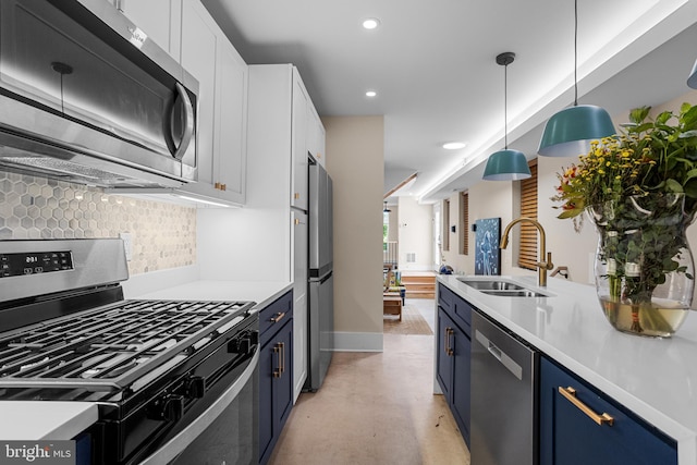 kitchen featuring stainless steel appliances, white cabinetry, sink, and pendant lighting