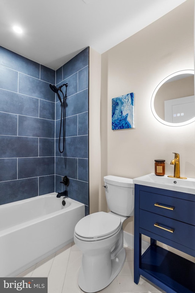 full bathroom featuring vanity, tile patterned flooring, toilet, and tiled shower / bath combo