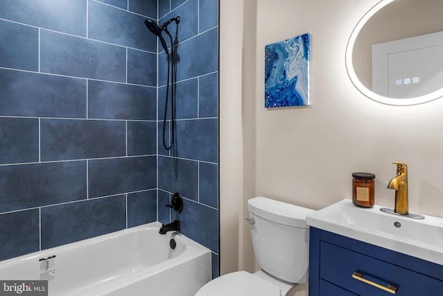 full bathroom featuring toilet, tiled shower / bath combo, and vanity