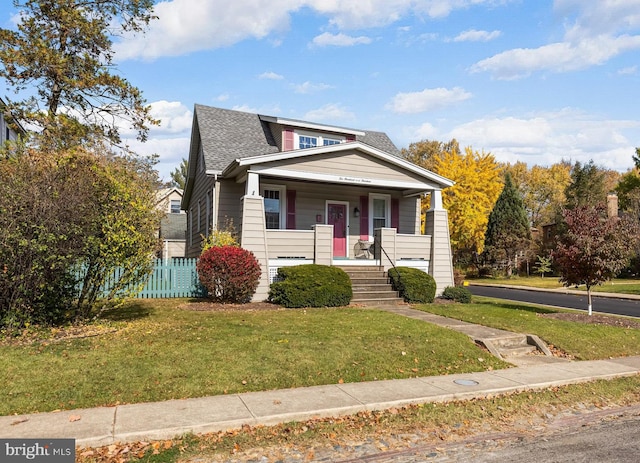 bungalow-style home featuring a porch and a front lawn