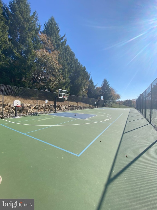 view of basketball court with community basketball court and fence