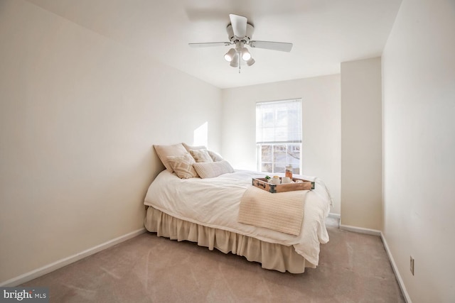 bedroom with light colored carpet, ceiling fan, and baseboards