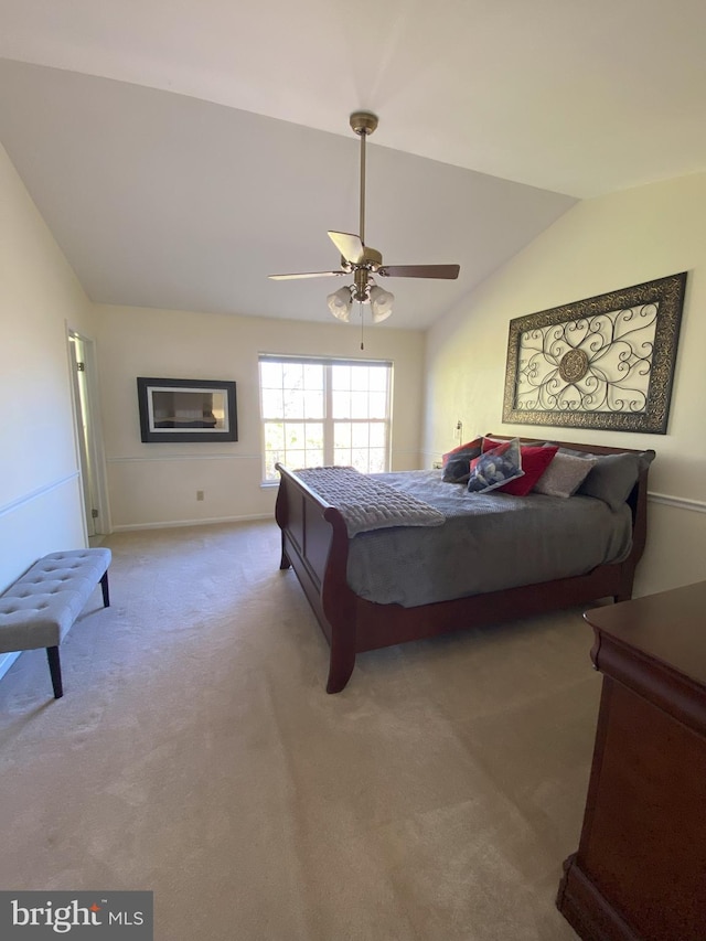 carpeted bedroom with vaulted ceiling and ceiling fan