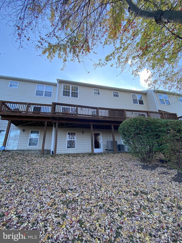 rear view of property featuring a wooden deck