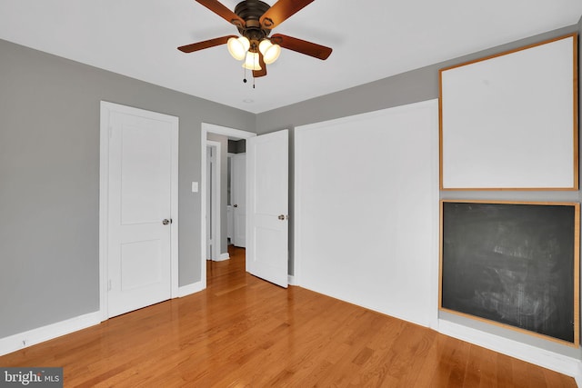 unfurnished bedroom featuring hardwood / wood-style floors and ceiling fan