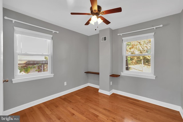 unfurnished room with hardwood / wood-style floors and ceiling fan