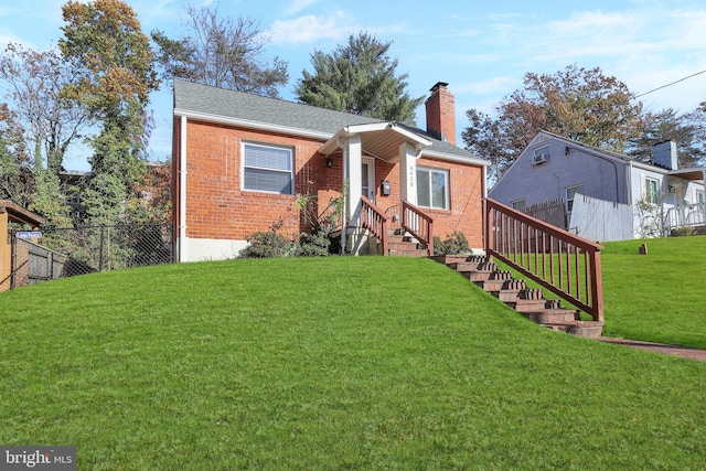 bungalow-style house with a front yard