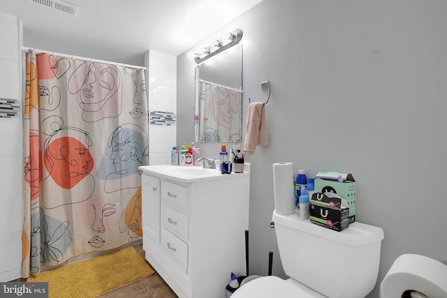 bathroom with toilet, vanity, a shower with shower curtain, and tile patterned floors