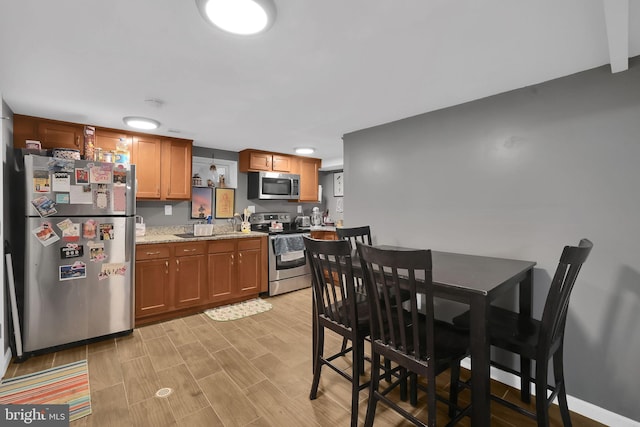 kitchen with light stone counters and stainless steel appliances