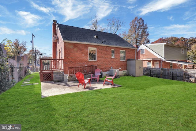 rear view of house with central air condition unit, a lawn, and a patio