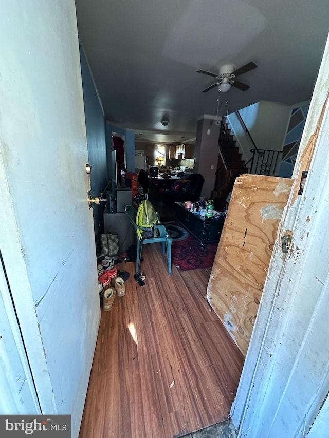 interior space featuring wood-type flooring and ceiling fan