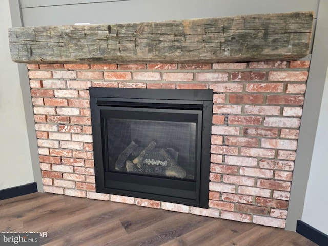 details with a fireplace and wood-type flooring