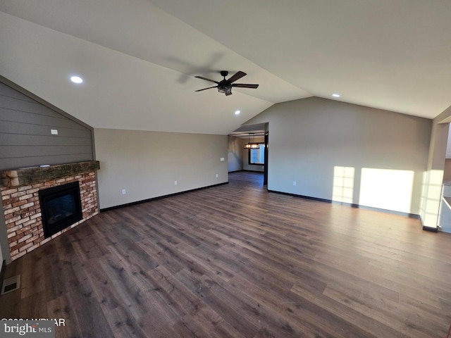 unfurnished living room featuring a fireplace, ceiling fan, dark hardwood / wood-style floors, and vaulted ceiling